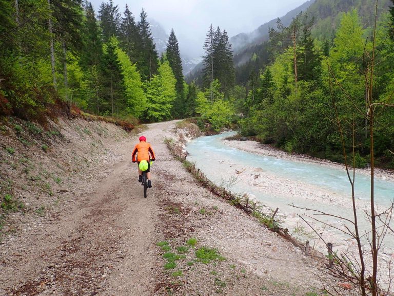 Gravel biking path to Vrsic pass around turquoise Pisnica river..., still raining.